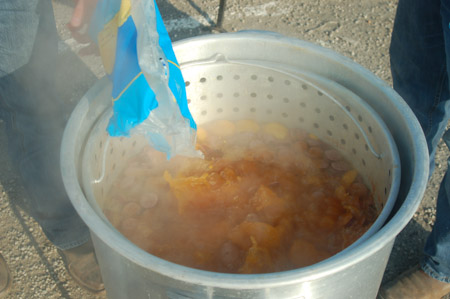 Adding corn to the crawfish boil