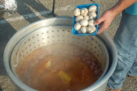 Adding mushrooms to the crawfish boil