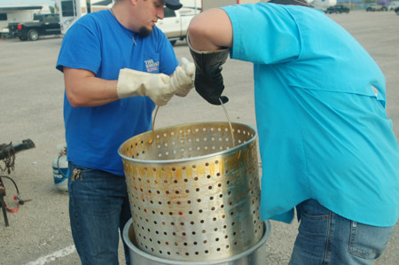 Removing the strainer from the crawfish boil