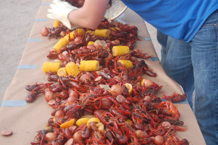 Pooring the crawfish boil on butcher paper